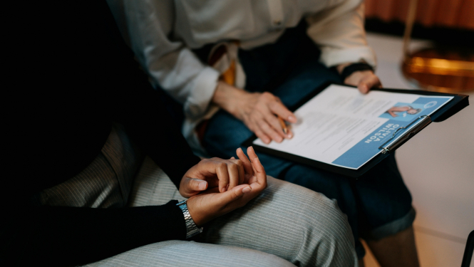 divi cilvēki tur dokumentu - lilustratīvs attēls